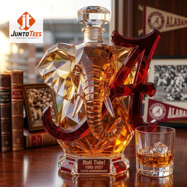 Geometric glass elephant decanter with crimson logo on a study desk.