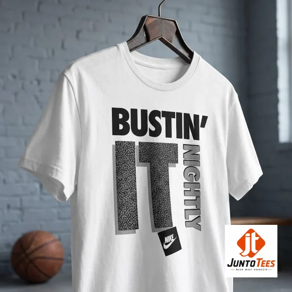 CJ McCollum Nike "Bustin' It Nightly" graphic t-shirt 5 A front view of a white crew neck t-shirt showing the stylized Bustin' It Nightly graphic. (Detail view #6)