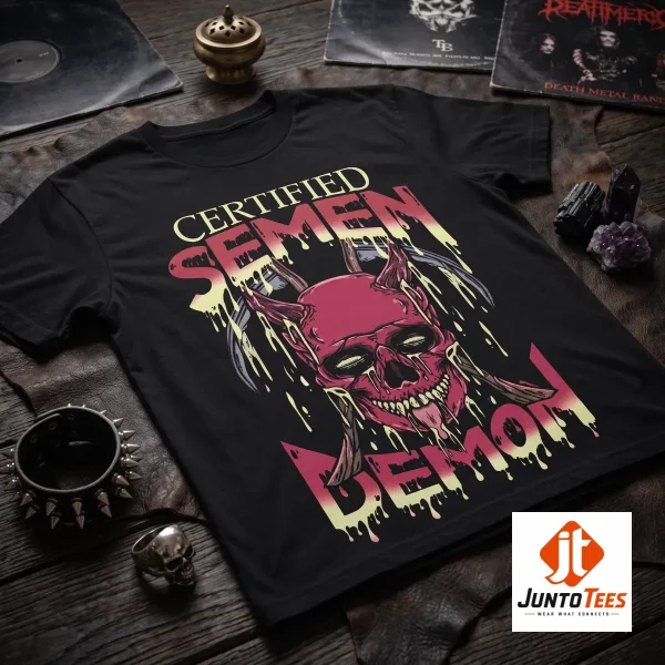 A black cotton crew neck shirt featuring a demonic skull graphic with scythes and melting text on a wooden surface.