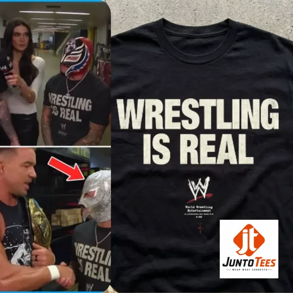 A close-up view of a black graphic t-shirt displaying white vintage-inspired Wrestling Is Real text.