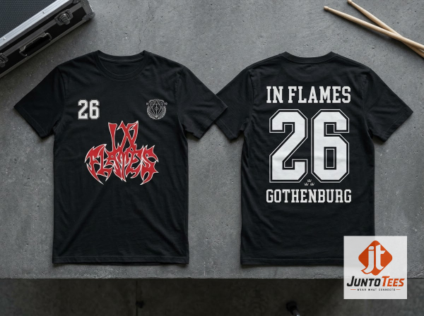Front view of black In Flames graphic t-shirt with red and white logo and number 26 on a concrete background.