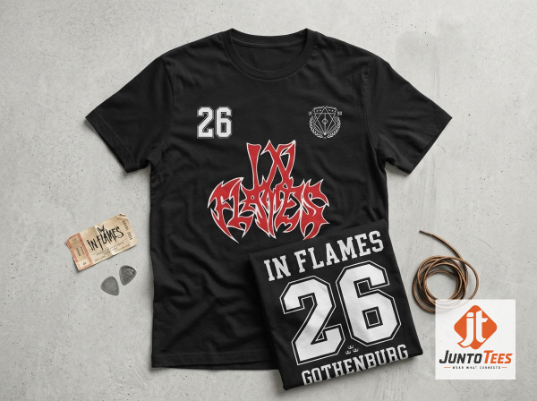 Front view of black In Flames graphic t-shirt with red and white logo and number 26 on a concrete background. (Detail view #3)