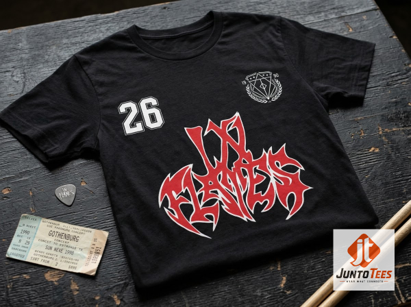 Front view of black In Flames graphic t-shirt with red and white logo and number 26 on a concrete background. (Detail view #4)