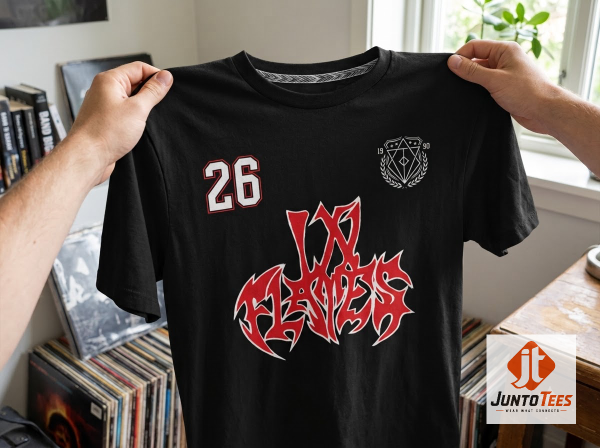 Front view of black In Flames graphic t-shirt with red and white logo and number 26 on a concrete background. (Detail view #6)