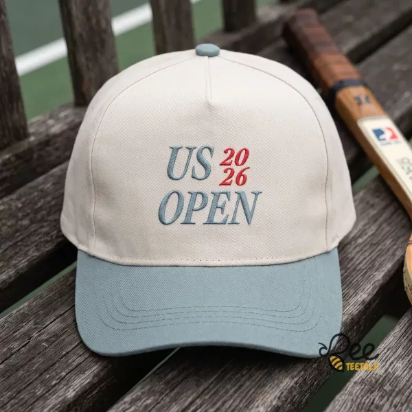 Close-up of a sage green corduroy US Open 2026 embroidered hat on a tennis court