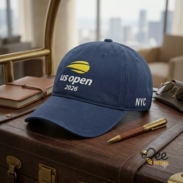 Navy blue US Open 2026 embroidered baseball cap on a tennis court bench (Detail view #3)